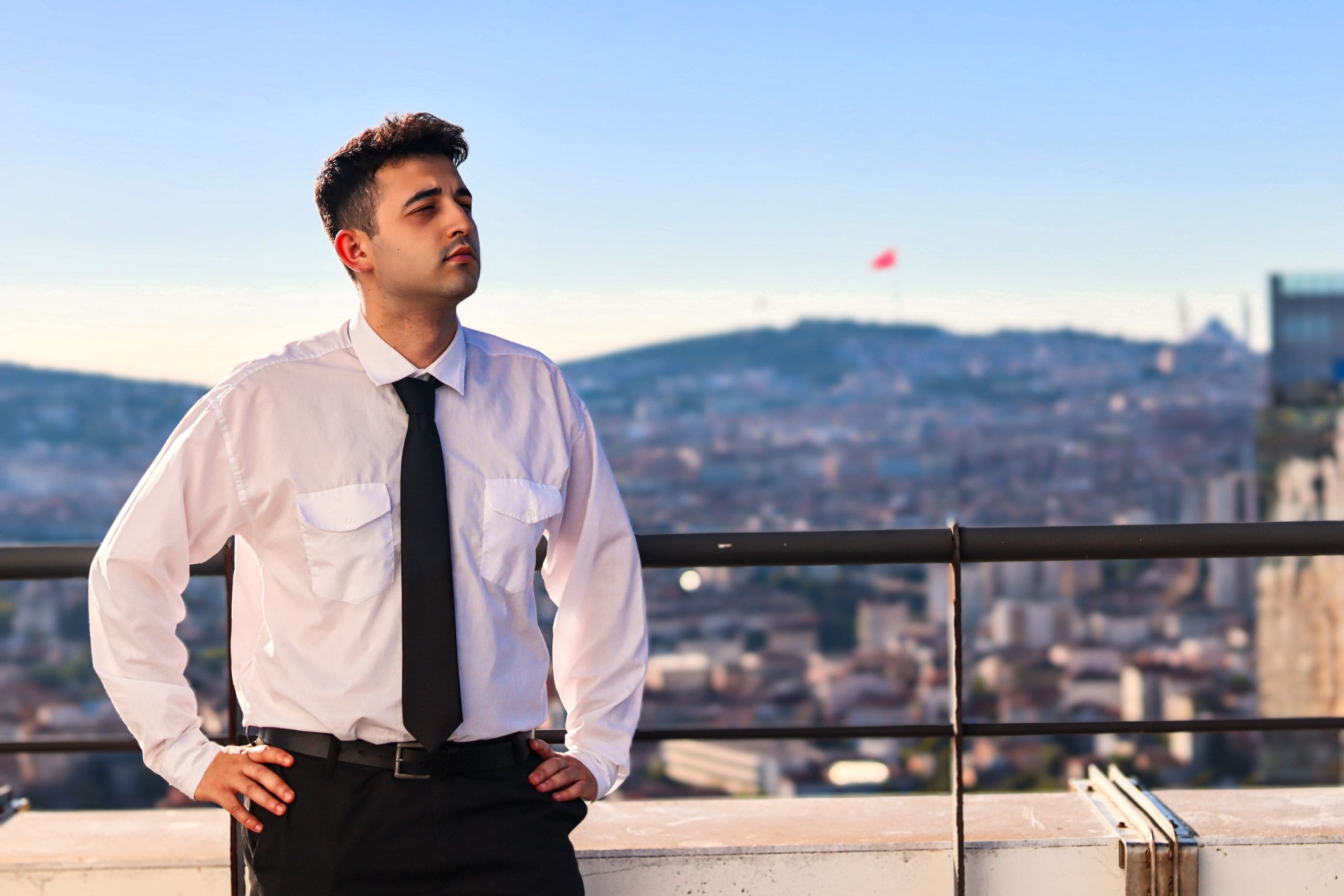 Advisor inspecting a commercial rooftop overlooking the city skyline
