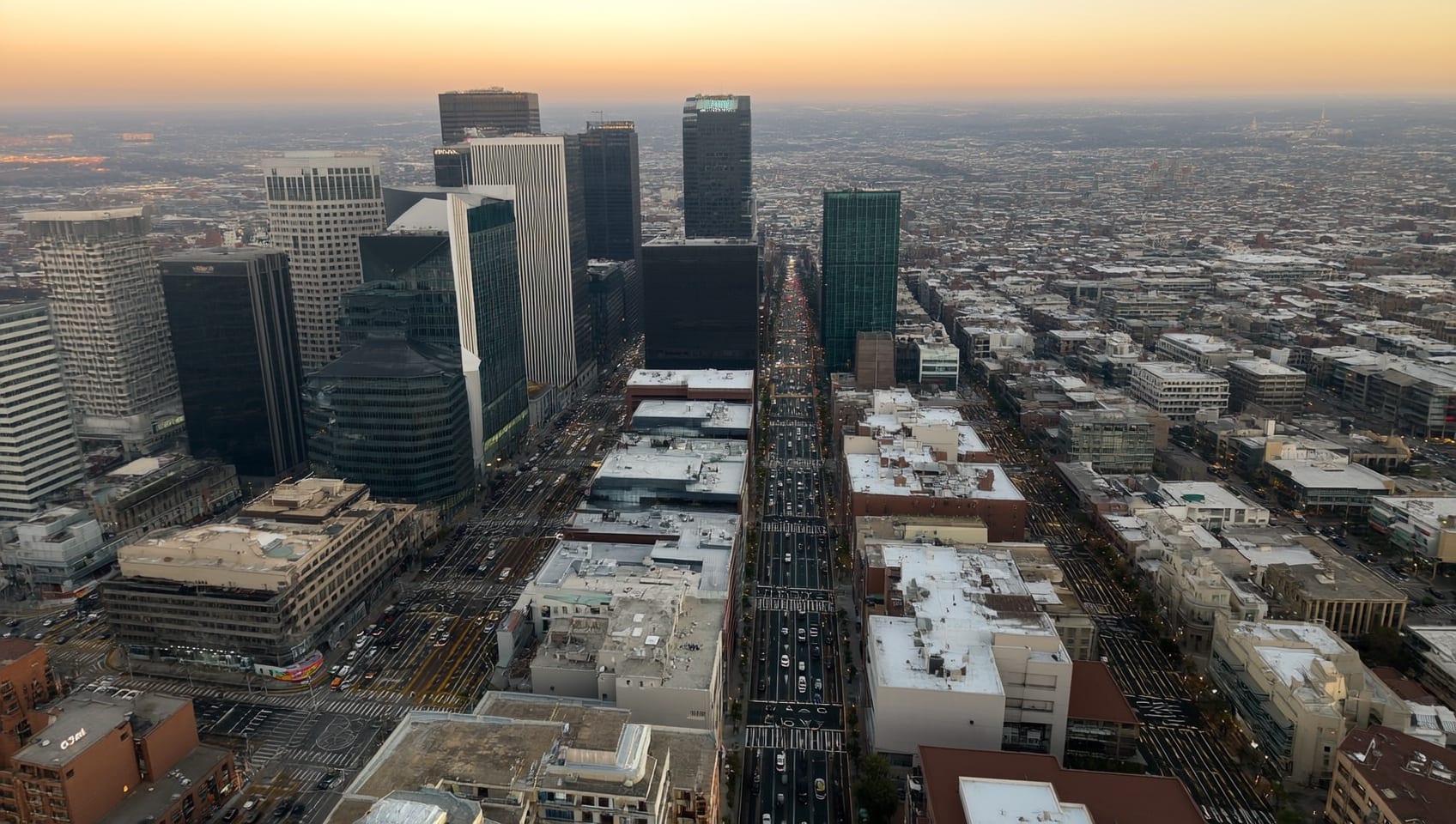 Aerial view of a dense commercial district with towers, streets, and rooftops