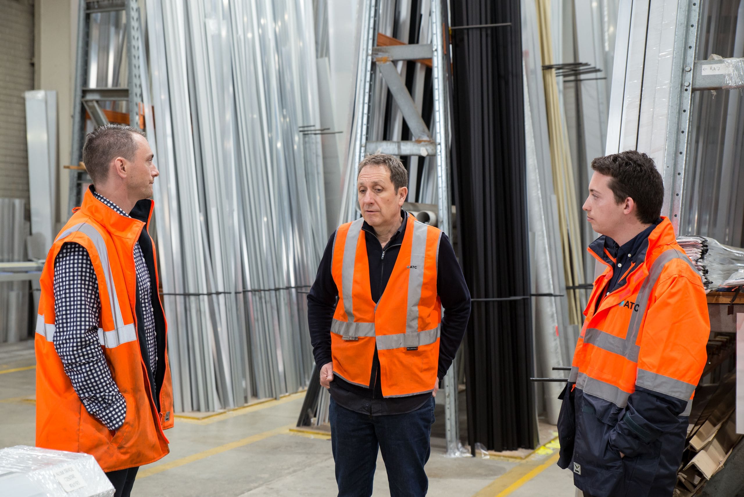 A team reviewing inventory on a tablet inside a distribution warehouse